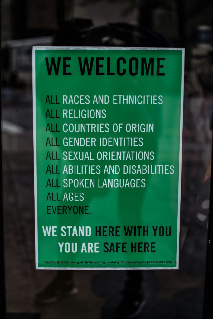 Image of a sign that says, “We welcome all races and ethnicities, all religions, all countries of origin, all gender identities, all sexual orientations, all abilities and disabilities, all spoken languages, all ages, everyone. We stand here with you. You are safe here.
