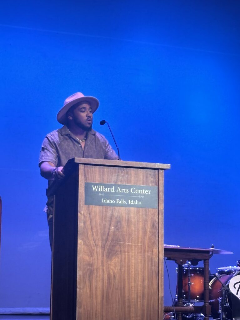 Performer and Coordinator Mosy Moran giving a statement at the Colonial House Juneteenth event.