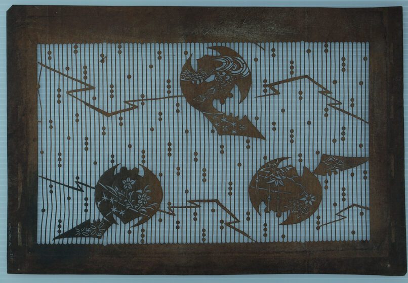  A delicate Japanese cut paper Katagami art showing three bats decorated in various nature motifs amongst vertical bamboo stripes.