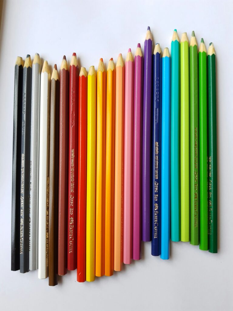A rainbow of colored pencils lined up, but not exactly so