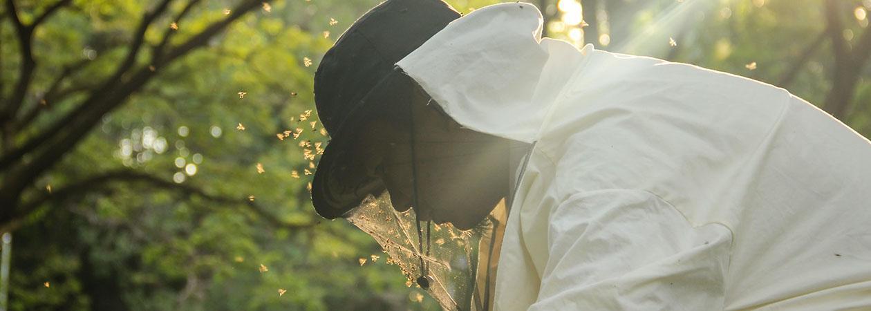 A person wearing a hat and a white shirt
Description automatically generated