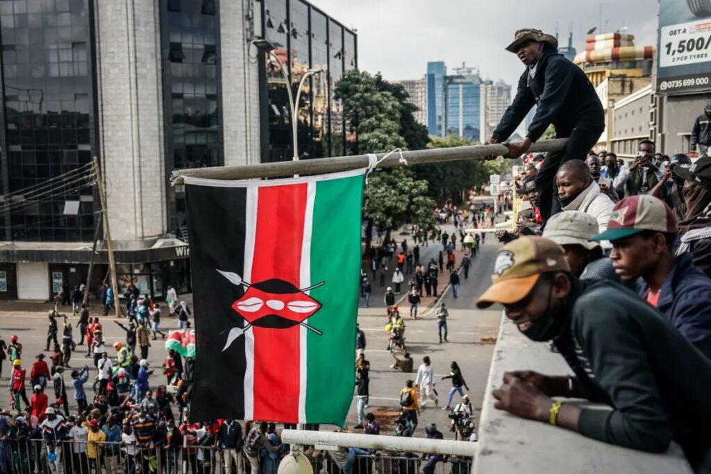 Protesters holding up the Kenyan flag. Photo by Al Jazeera, via X