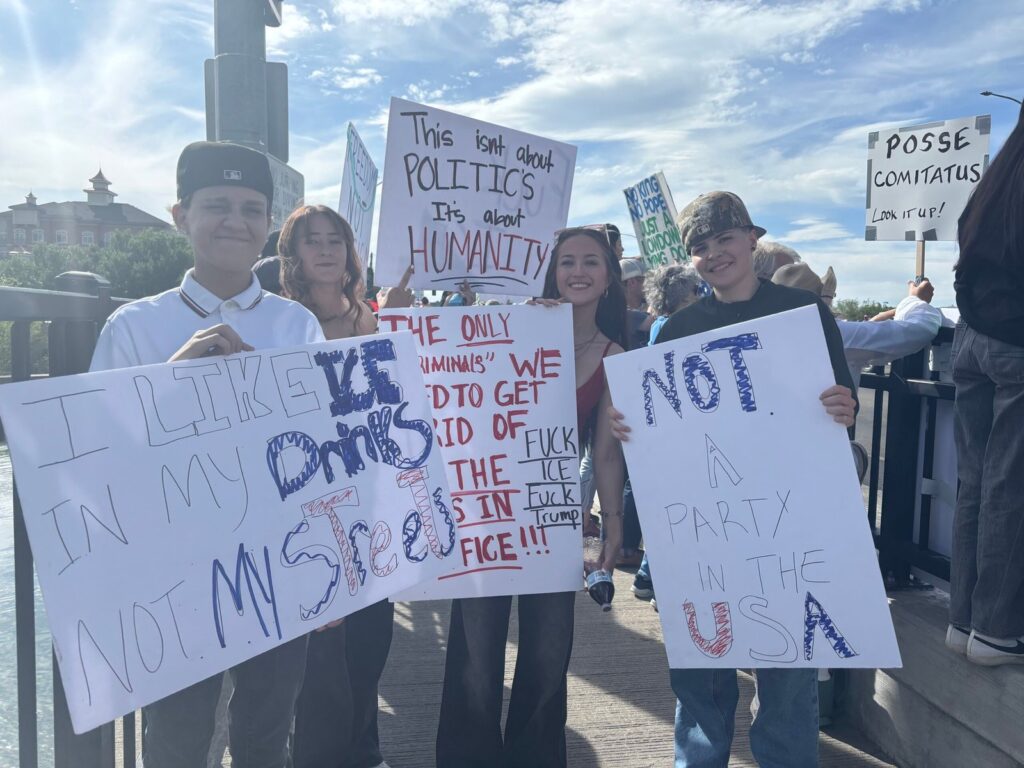 Young group of protestors advocating at the No Kings Rally by Gracie Leavitt