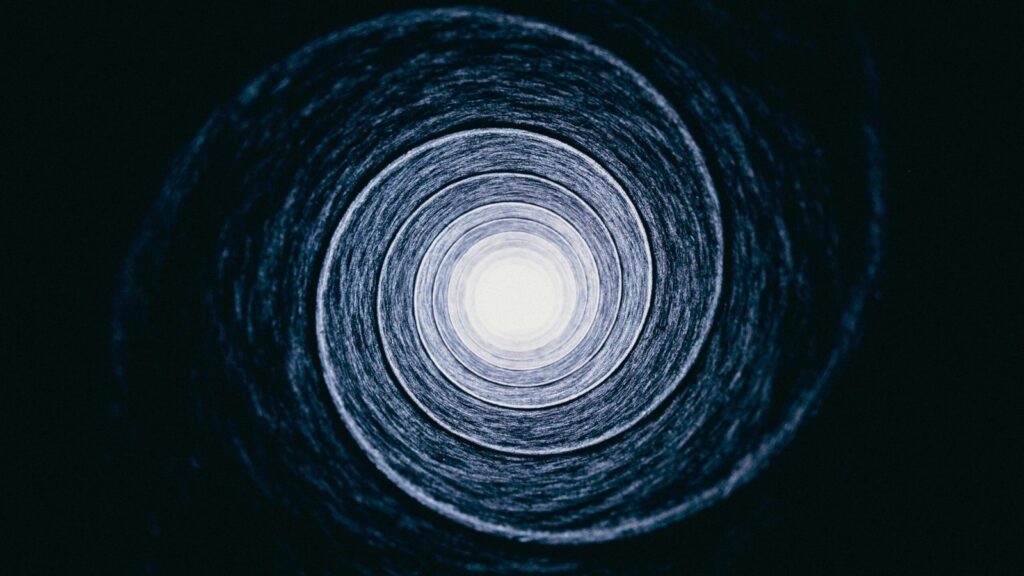 A spiral in black and white, a nebula intentionally nebulous; it could be taken from the bottom of a well.
