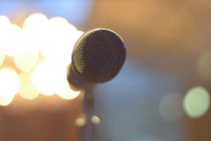 An empty microphone is surrounded by glowing lights.