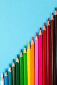 A rainbow of sharpened colored pencils lined up at a precise angle