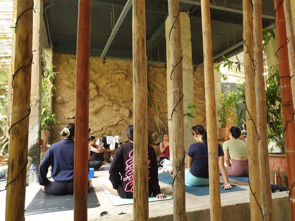 A group of people sitting together on yoga mats.