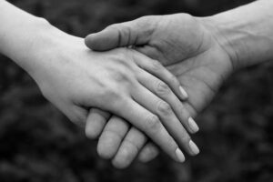 Two people holding hands