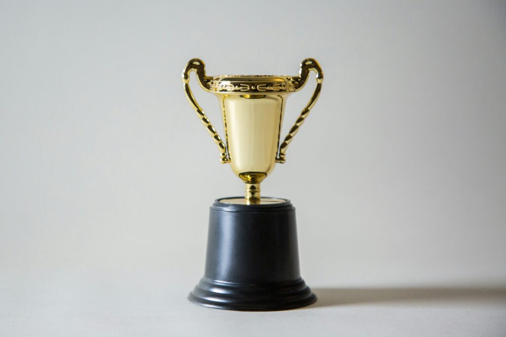 A gold trophy against a white background. 