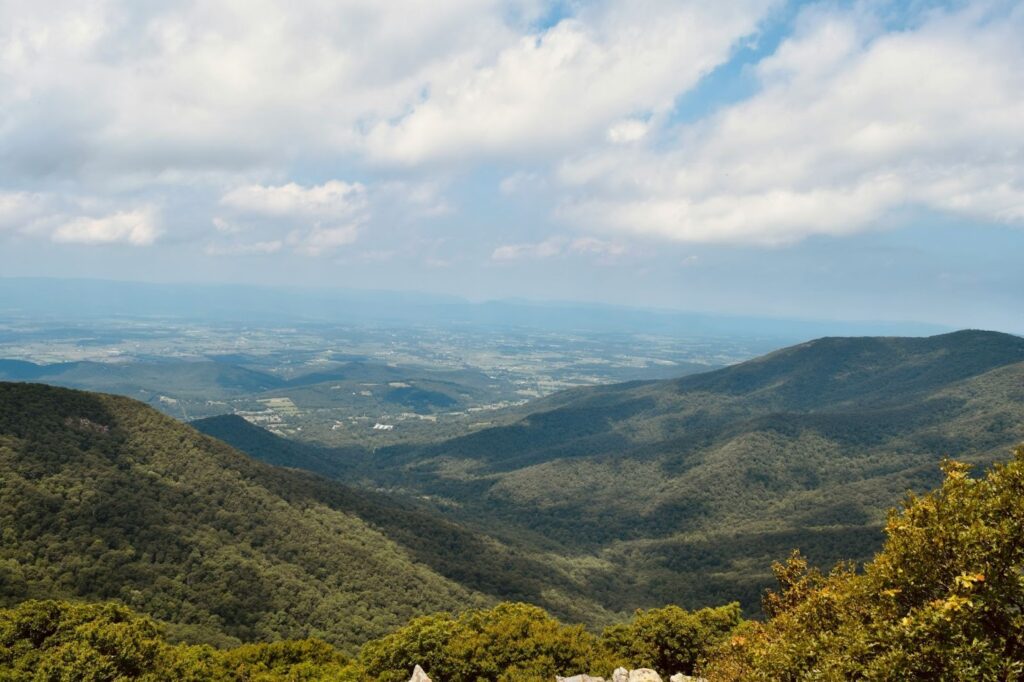 Image of the Shenandoah Valley in Virginia. Mountains loom under rolling clouds.