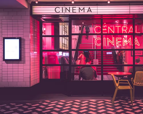 Movie theater with neon sigh reading “Cinema”