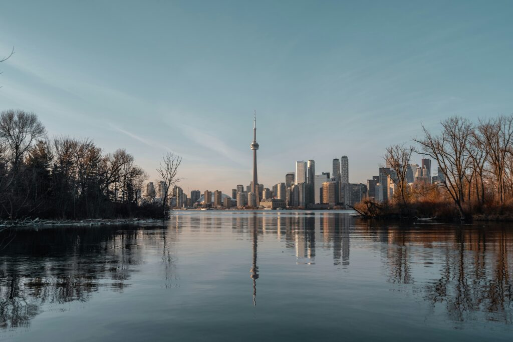 An image of the Toronto skyline and its reflection shining in Lake Ontario. 