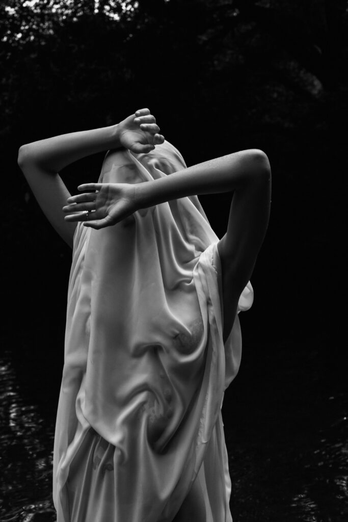 A figure covered with a sheet. 