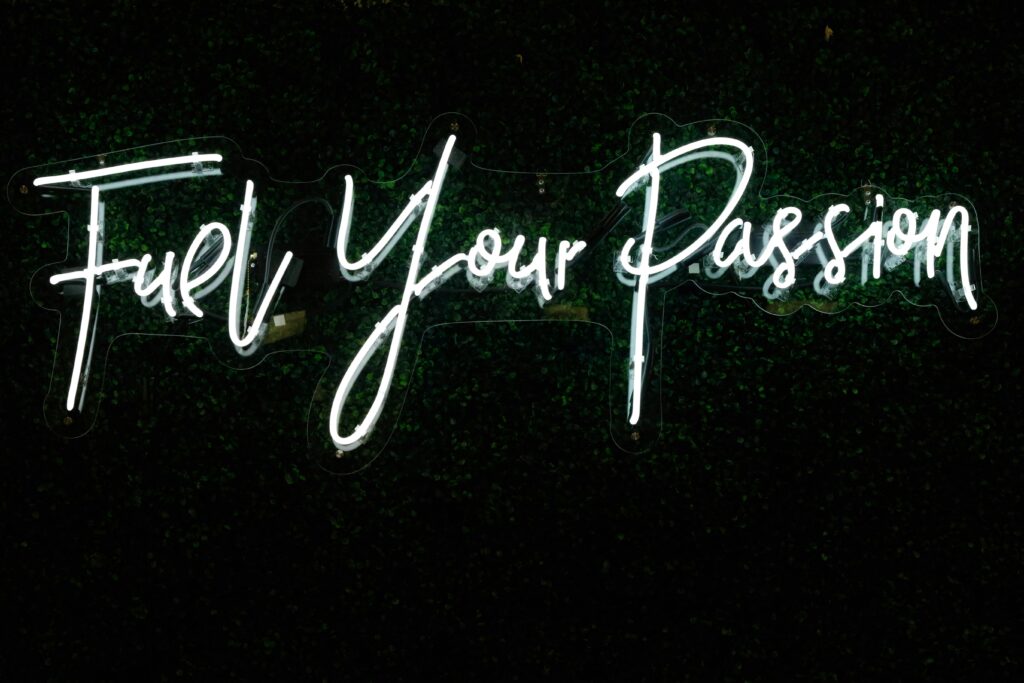 A neon sign that reads “Fuel Your Passion” in semi-cursive script