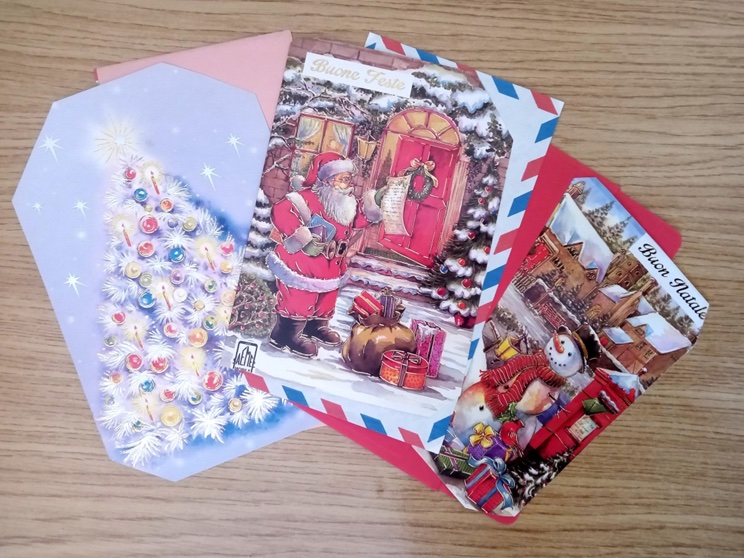 A series of Christmas cards in various traditional styles.