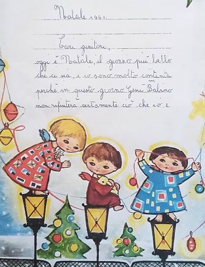 A Christmas card, featuring children with writing in Italian. 