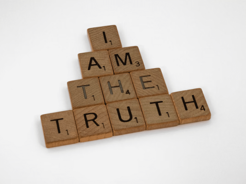 Wooden Scrabble tiles spell out “I am the truth”.