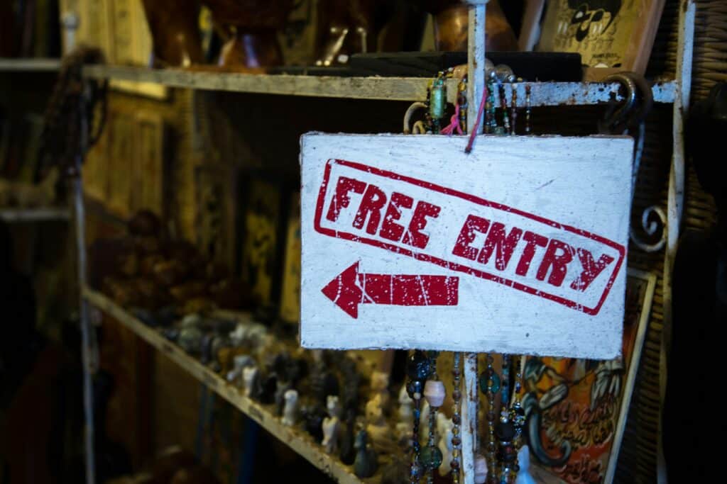 A sign reads “free entry” in red print with a pointing arrow.