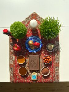 A table topped with bowls of food in honor of Nowruz, the Iranian or Persian New Year’s Day. | Image courtesy of Pouya Jabbarisani via Unsplash