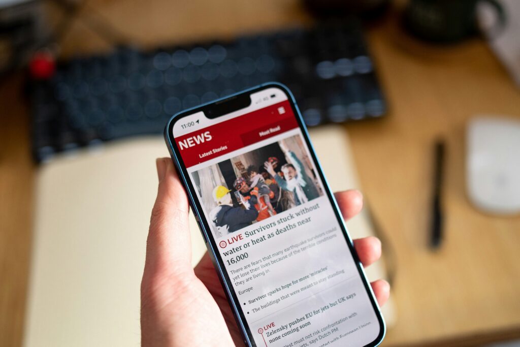 Breaking News. A person holding a phone. Photo by Rich Tervet on Unsplash