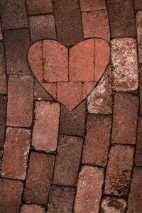 A heart shape in paving stones bridges differing paved paths.