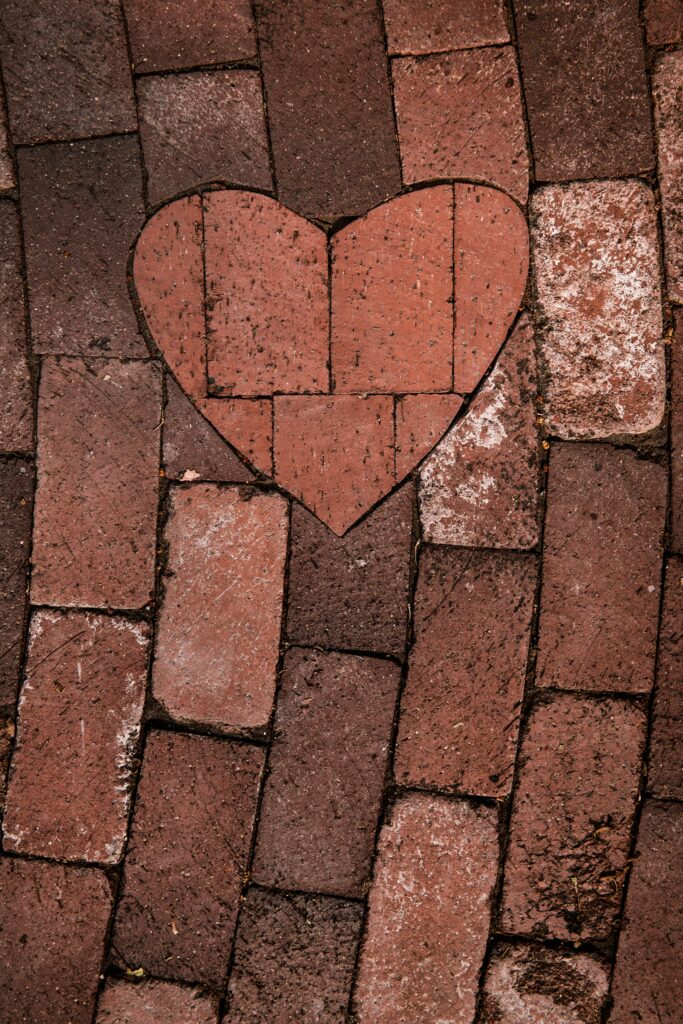 A heart shape in paving stones bridges differing paved paths.
