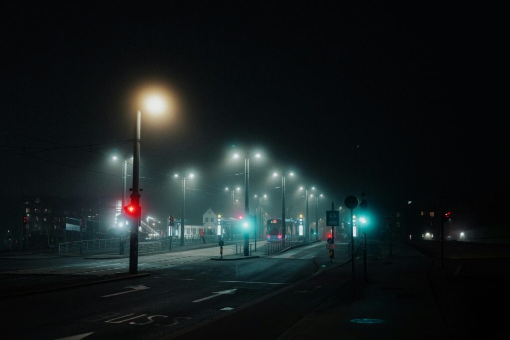 Image of Oslo at night, with streetlights gleaming through fog.