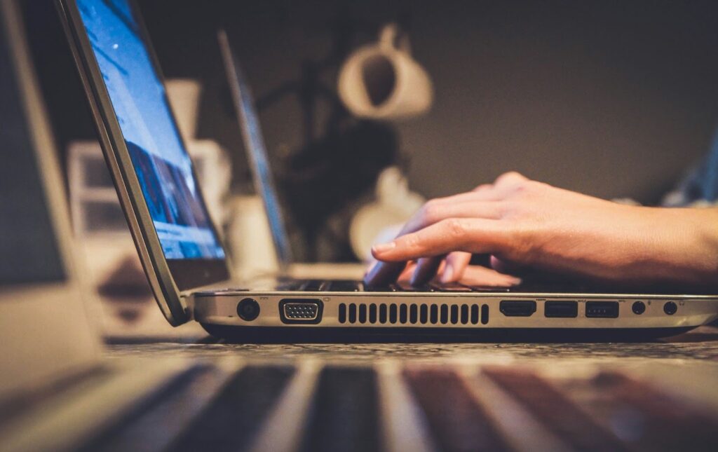Image of a person typing on a laptop.