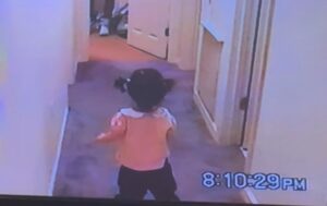 A young girl takes her first steps in the hallway of her childhood home. Her parents and grandparents witness the moment.