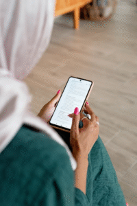 A woman reading text on her phone.