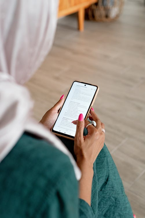 A woman reading text on her phone.