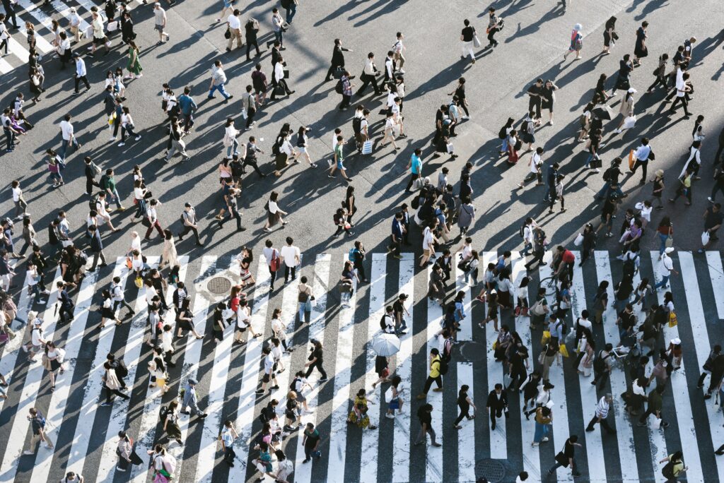 An overhead view of a busy crosswalk filled with people.