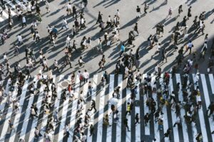 An overhead view of a busy crosswalk filled with people.