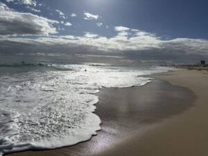 Waves crashing on the shore of Scarborough Beach in Australia.