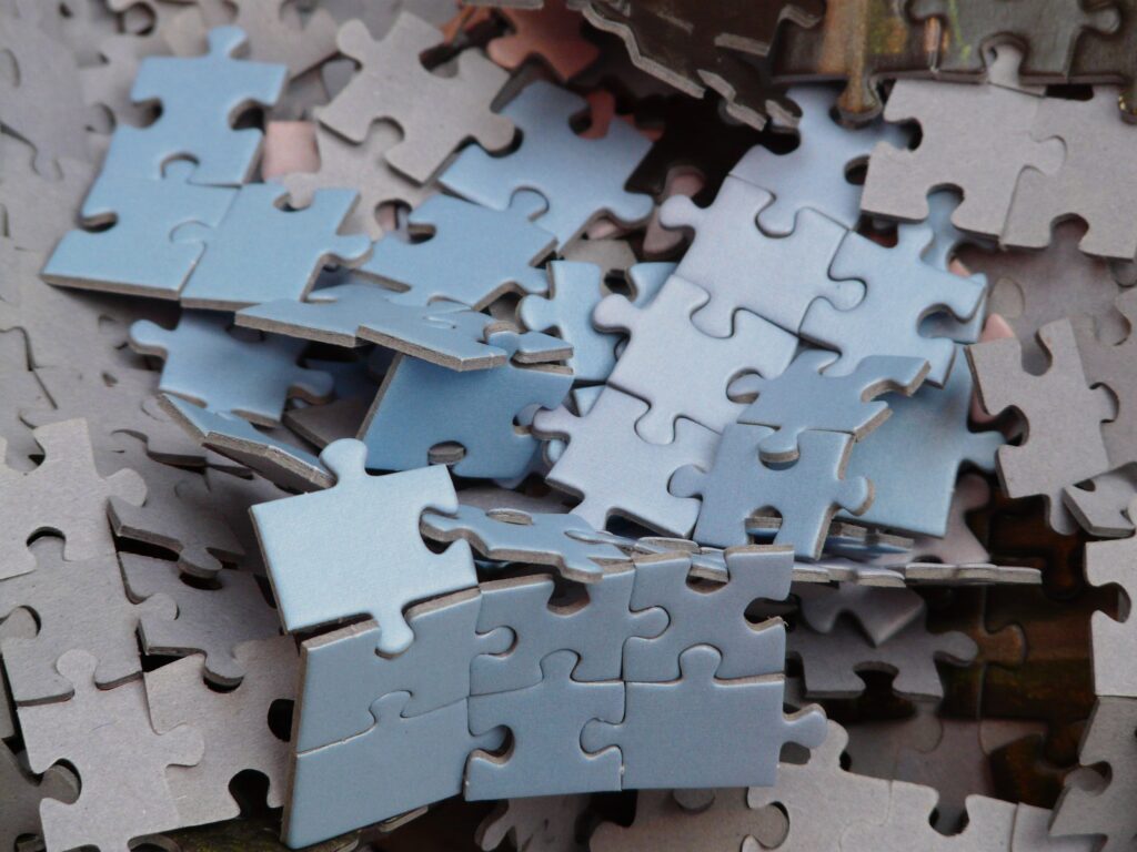 Fragments of an unfinished blue puzzle in a small pile.