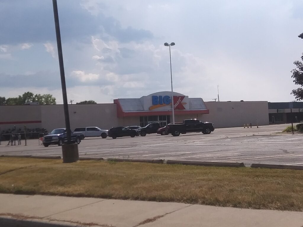 An abandoned Kmart storefront and parking lot.