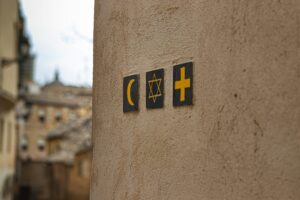 A depiction of three religious symbols from the major Abrahamic faiths.
